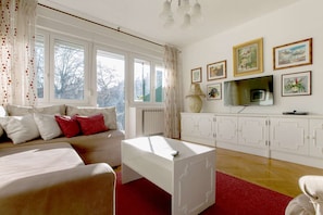 Living room with double sofa bed, smart TV and exit to the sunny terrace.