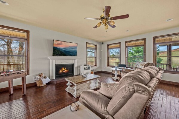 Spacious living room with a Smart TV, fireplace, and plenty of comfortable furniture.