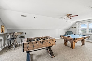 The renovated game room includes a brand new pool table, new foosball table, pub chairs and a Smart TV.