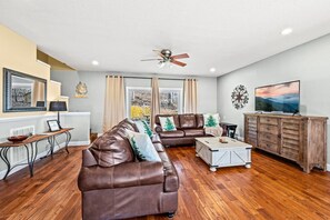 Spacious living with comfortable furniture and a new 55" Smart TV.