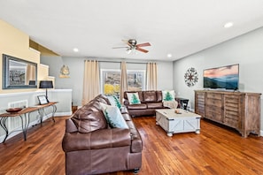 Spacious living with comfortable furniture and a new 55" Smart TV.