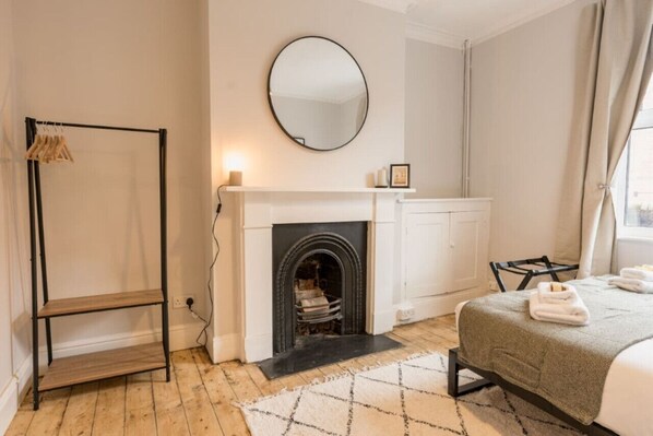 Downstairs Double Bedroom: Bedroom 1:  this spacious bedroom has a feature fireplace, adding character to the room.