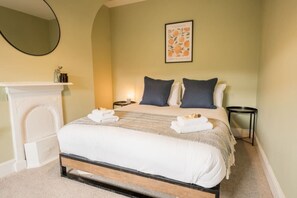 Upstairs Double bedroom - bedroom 3 - with king bed and earthy tones, perfect for a relaxing evening.