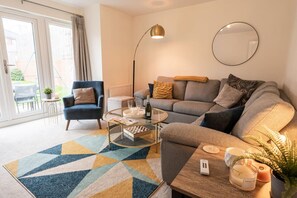 The Living Room: with plenty of natural light flooding into the living area, this is a perfect place to relax on the comfortable sofas.