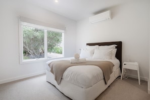 The primary bedroom offers split-system heating and cooling.