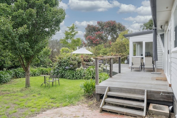 A grassy, pet-friendly backyard not only provides seating to savour a peaceful morning cuppa but also invites you to relax in the sun loungers for an extra touch of tranquillity.