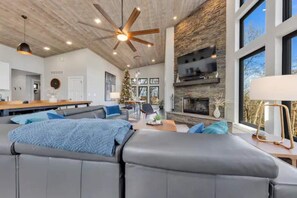 Living room featuring shiplap ceiling and floor-to-ceiling fireplace!