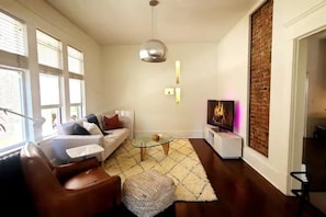 Retire in the living rm. for some lounging. Comfy armchair and sofabed included.
