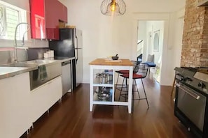 Looking to kitchen and office beyond, from your entry at the back of the house.