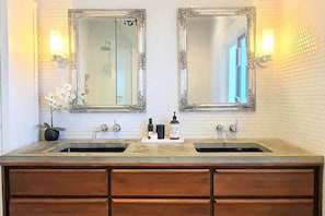 Luxurious bathroom with custom vanity, double sinks & heated floors. 