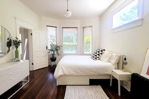 Bright and spacious bedroom with an open lofty feel. Storage and dark blinds. 