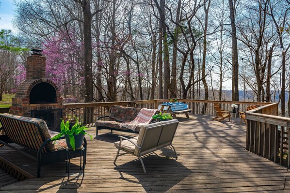 Relaxing deck with lounging area, picnic table, chairs, grill and outdoor games.