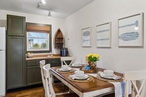 Dining room table, can seat up to 6 adults (2 extra chairs provided near table).