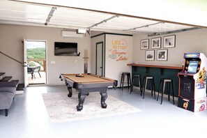 Game Room with A/C Unit, Pool Table, Pac-Man Arcade Game, and TV.