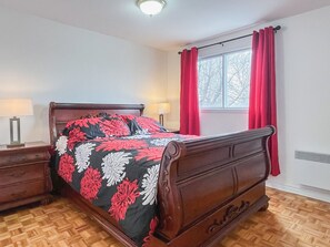 First bedroom with a queen bed and walk in closet