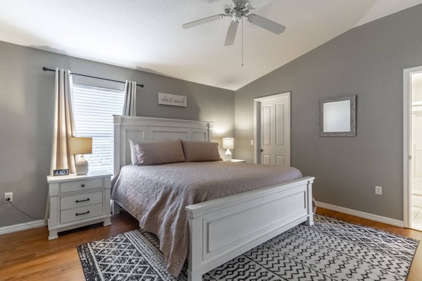 Cozy master bedroom with hardwood floors and King Sized bed