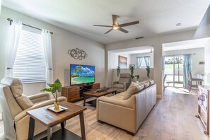 Spacious Living Area With Leather Seating and Flat Screen TV