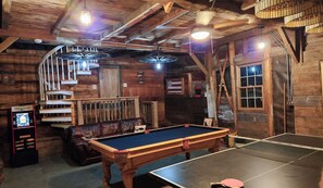 Large game room with pool table, ping pong, air hocky, packman, spiral staircase