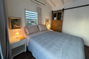 Bedroom with unique lights and vintage artwork by Paul Toporowski