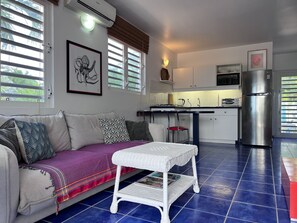 Living room with very comfy couch into kitchen