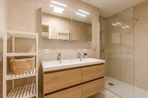 Well-designed bathroom with walk-in shower and double sink