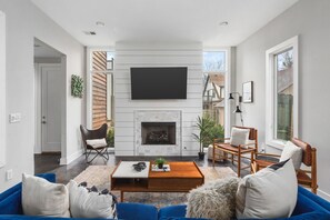 Spacious yet cozy living room with lots of natural light, a Smart TV, and plenty of seating.