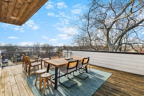 Private rooftop deck with a dining table and plenty of seating for you to enjoy the sunshine.