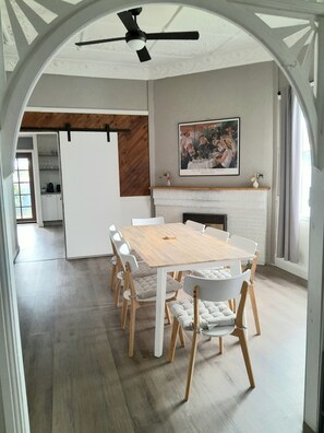 Dining room for 8 with ornate ceilings and fireplace. 