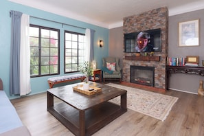 vibrant throw pillows, and large windows that bring the garden view indoors.