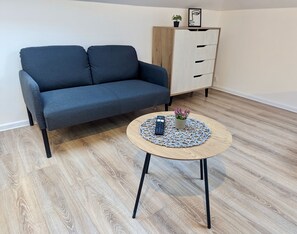 Sofa, smart Tv and kitchenette fully equipped. (1)