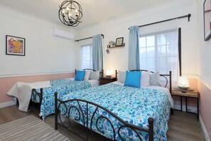 This inviting bedroom offers two cozy queen beds