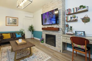 A decorative fireplace, air conditioning, and a smart TV for ultimate comfort.