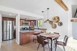 Savor a meal in this inviting dining space adjacent to the kitchen.