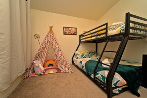 Third bedroom featuring a bunk bed and play tent.
