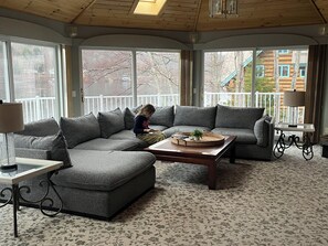 Living room with sectional and 180 degree view of Mascoma Lake