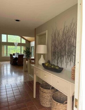 Front Foyer that lure you into the dining room with wall of  glass. 