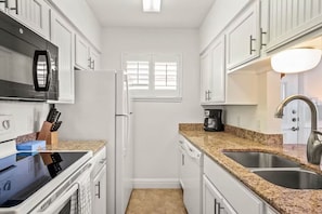 The kitchen has a cooking and dinnerware dishwasher, full-size appliances 