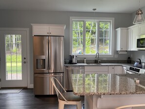 Kitchen, stainless steel appliances, electric stove, microwave, toaster, coffee