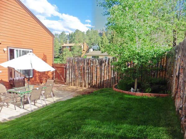 private outside eating area with garden evening lighting.