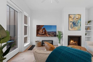 Gas Fireplace, Original artwork and 75" TV make for a great living space.