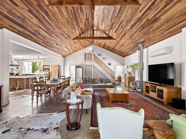 Sink into the soft sofas beneath soaring marri timber ceilings, light the fire on cooler evenings, and unwind with your favourite film in this inviting open-plan area.