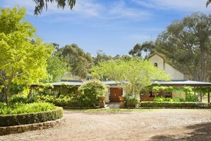 Arrive to the calming embrace of nature, where a handcrafted country home nestles among vineyards, native trees, and lush rolling lawns.