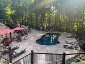 Beautiful community pool surrounded by trees.