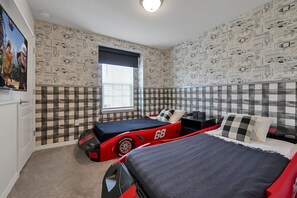 Dream in a fun race car bed in this playful, Disney-themed kids' room. Cozy, creative, and close to the magic!
