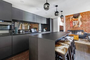 The sleek kitchen makes it easy to whip up a feast at home with high-quality appliances and ample bench space.
