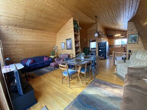 Living room with smart TV and two seating areas