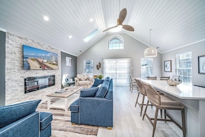 Cozy, coastal living room with modern finishes and a tranquil fireplace 