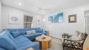 A cozy living room with plush furniture, soft lighting, and tasteful decor invites relaxation and warm conversations.