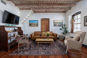 Gather around for family game night in the inviting living room, complete with board games and comfortable seating.