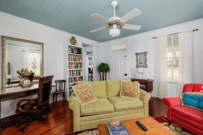 Bask in the natural light streaming through the windows of the living room, illuminating the space and highlighting its charming design